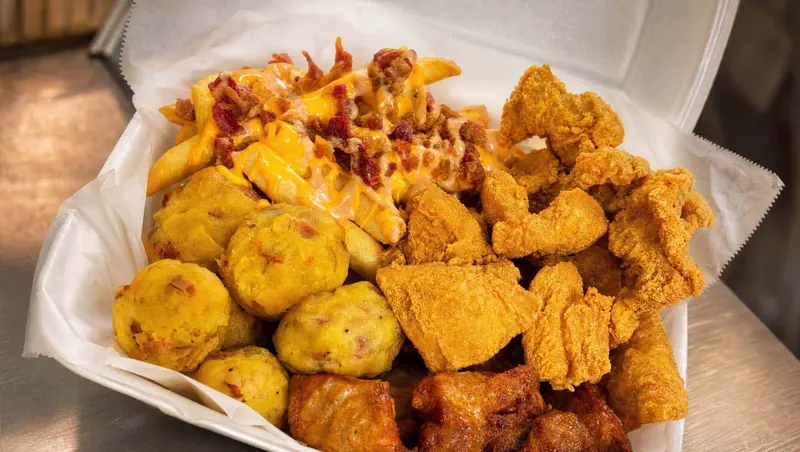 Bolitas de mofongo and papas con queso y bacon alongside crispy fried chicken